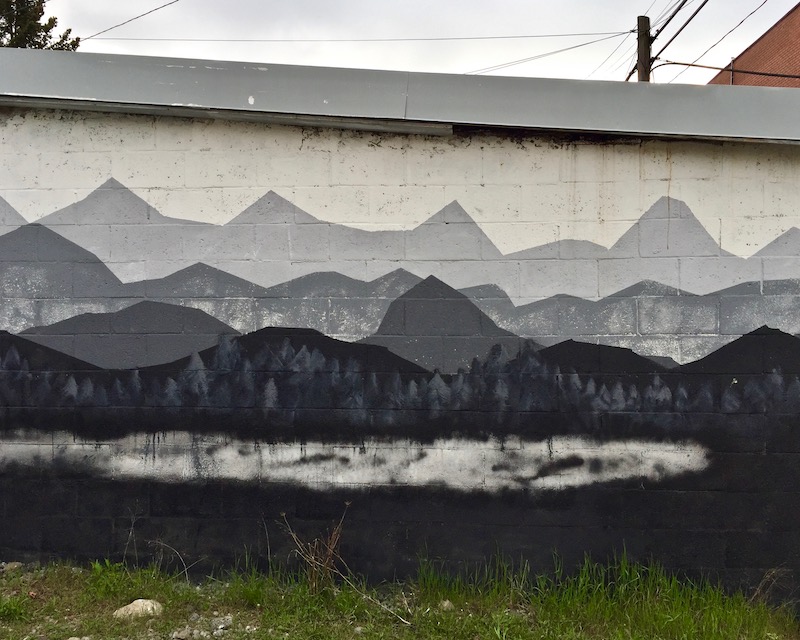mural of mountains on cinderblock garage