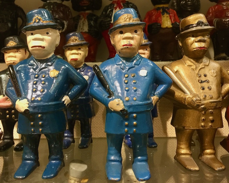 antique metal toy figures of police officers