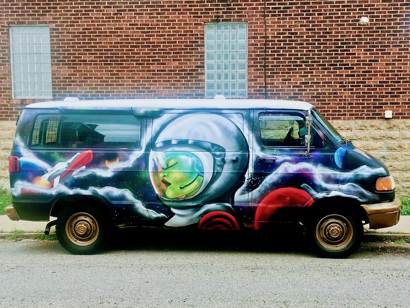 custom van with elaborate painting of woman in space suit