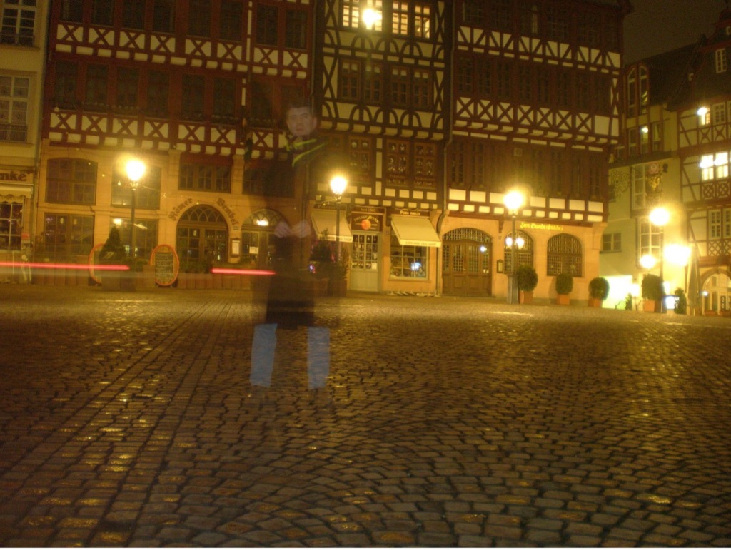 double-exposure image of man in empty German town square