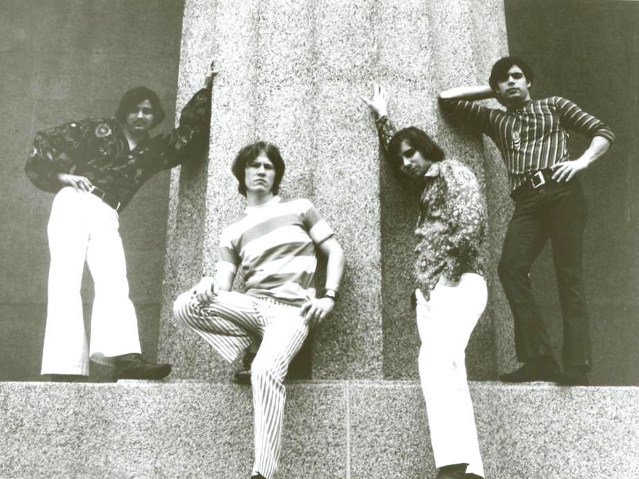 rock band The Rugbys posing in front of a stone column